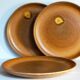 Four vintage glazed stoneware potter's plates