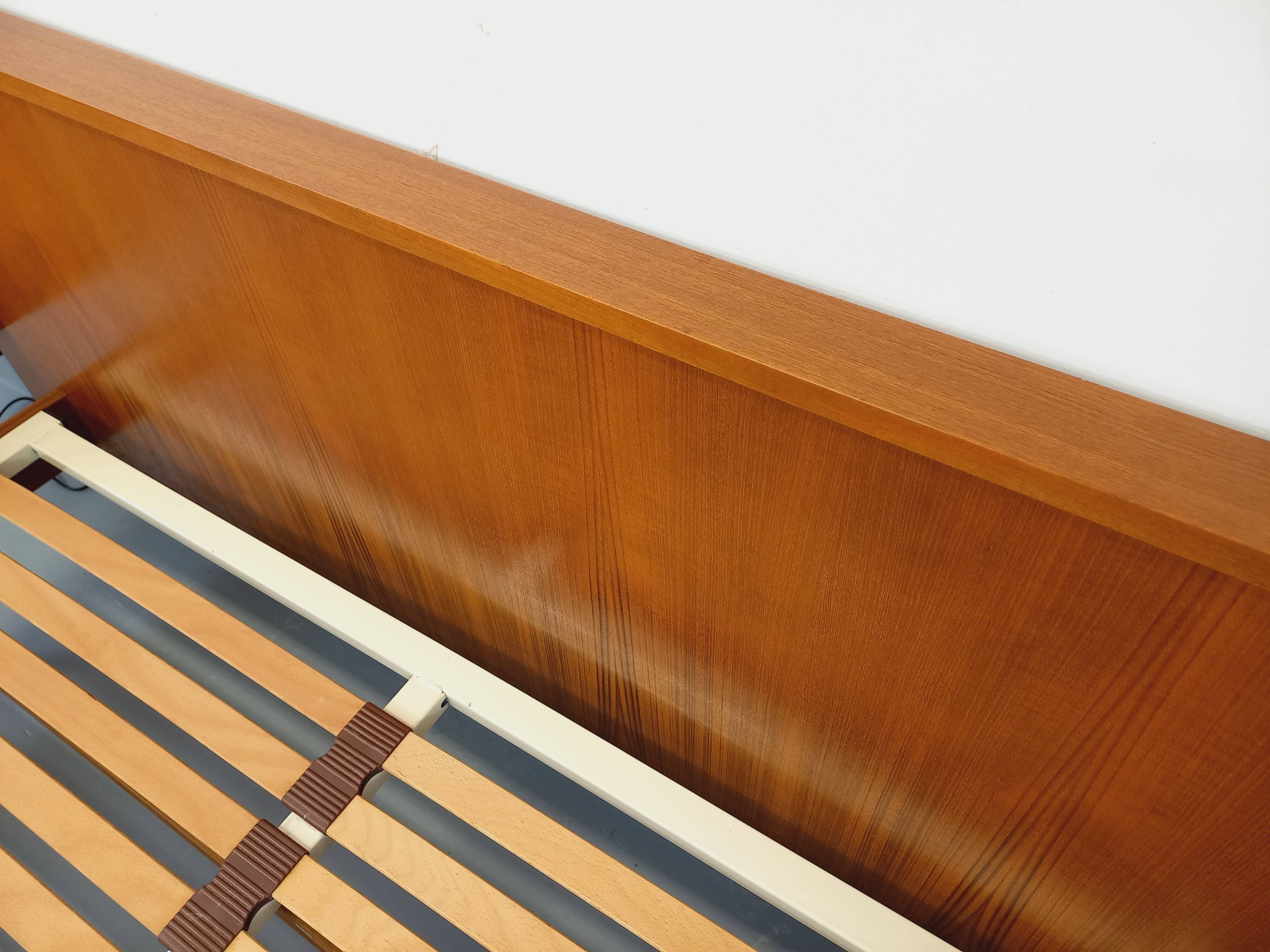 Double bed in vintage Scandinavian style from the 1960s with bedside tables in teak.