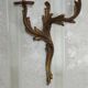 Apply two bronze wall lights decorated with acanthus leaves.