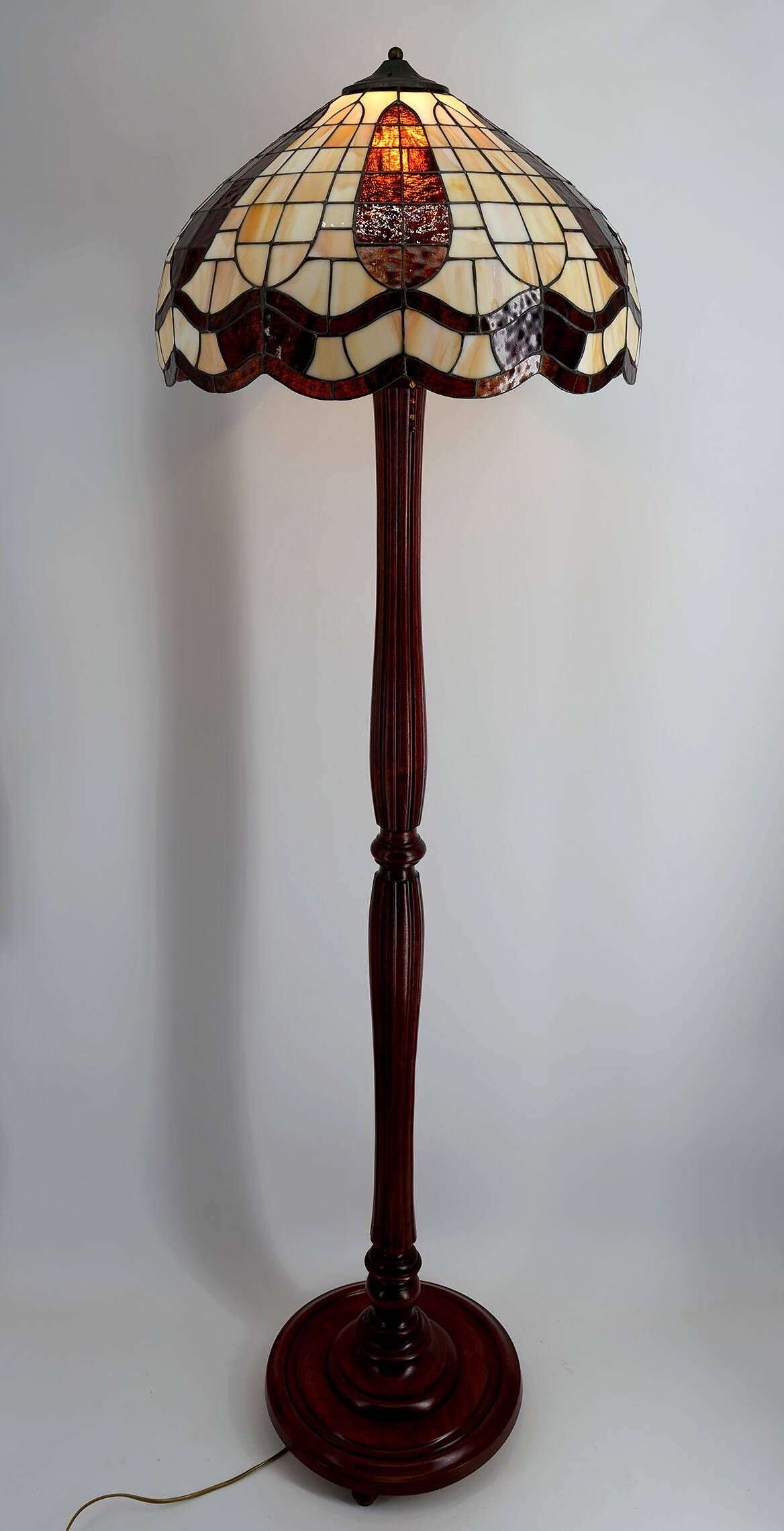 Art Deco floor lamp in carved walnut, stained glass shade, France, c. 1920