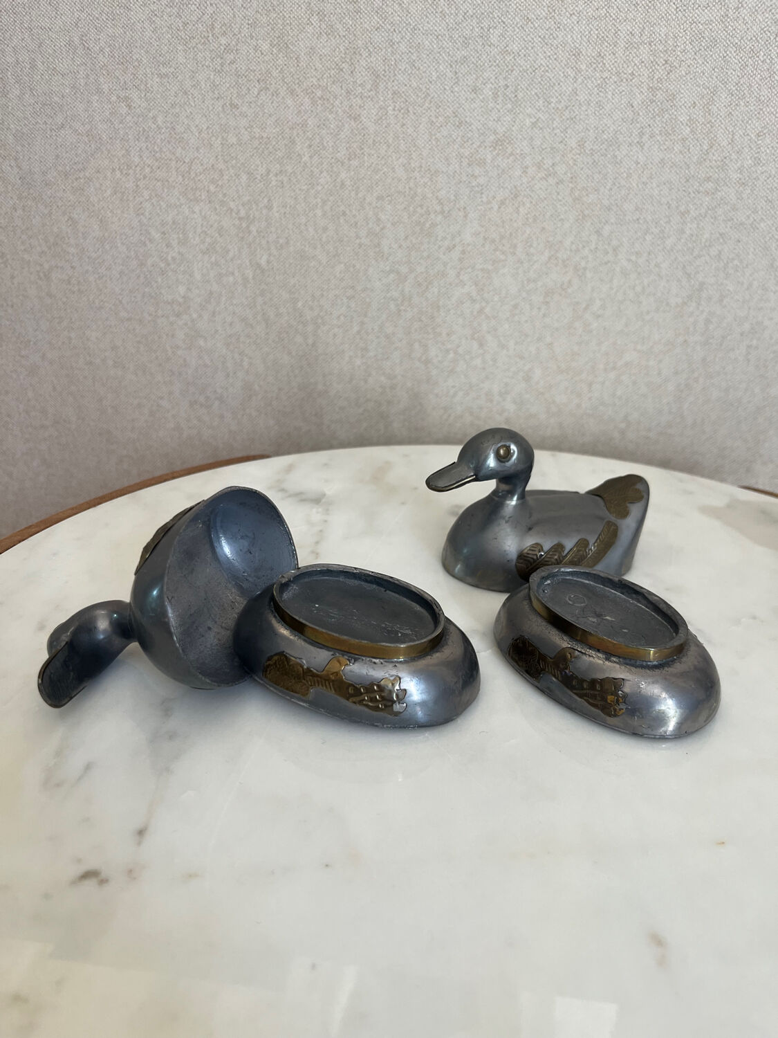 Pair of vintage decorative metal boxes in silver, shaped like ducks.
