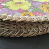 Top of the 60s in rattan braid wood bottom covered with a plastic with pink and yellow flower