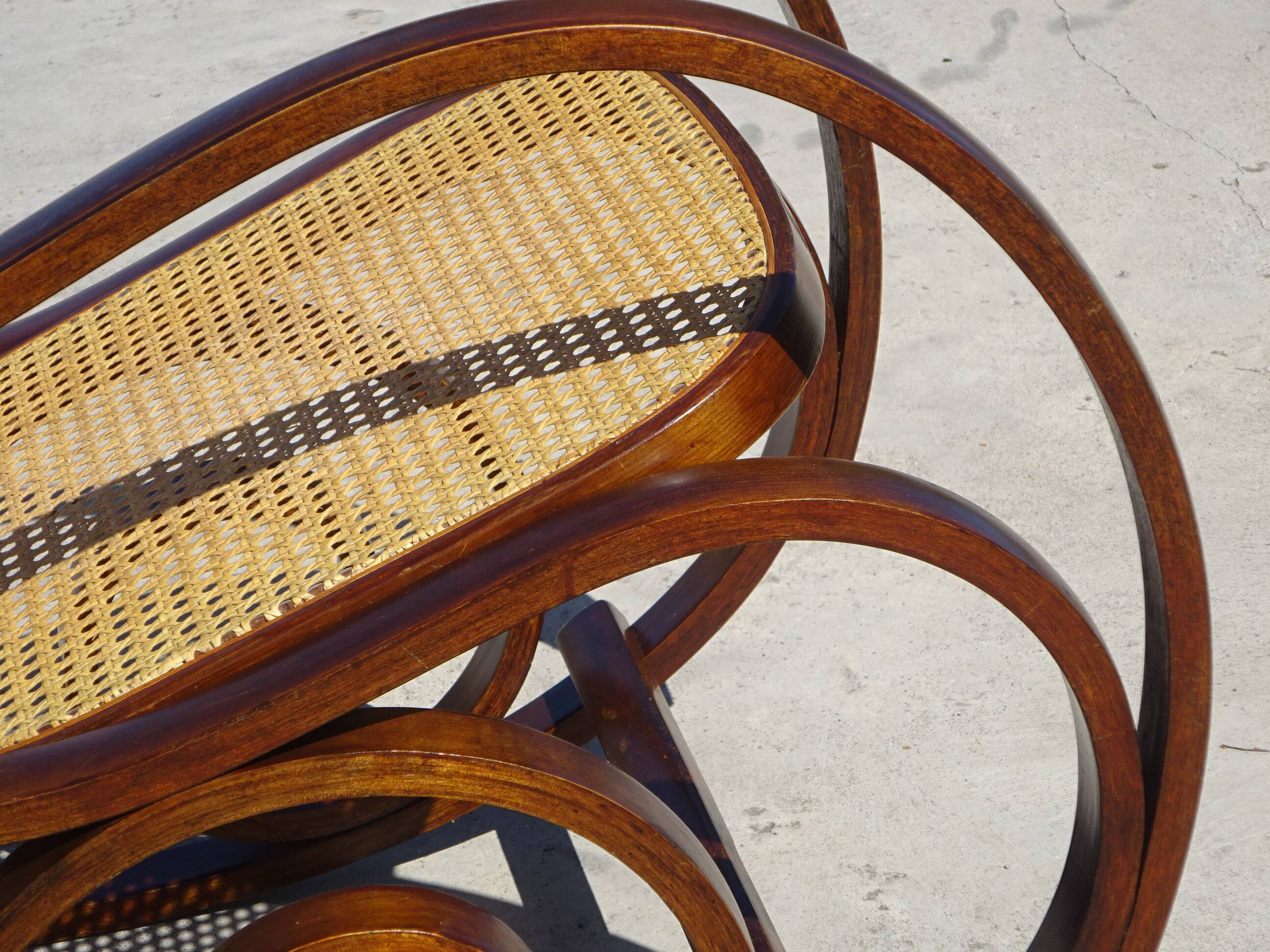 Vintage wooden rocking chair with caning