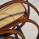 Vintage wooden rocking chair with caning