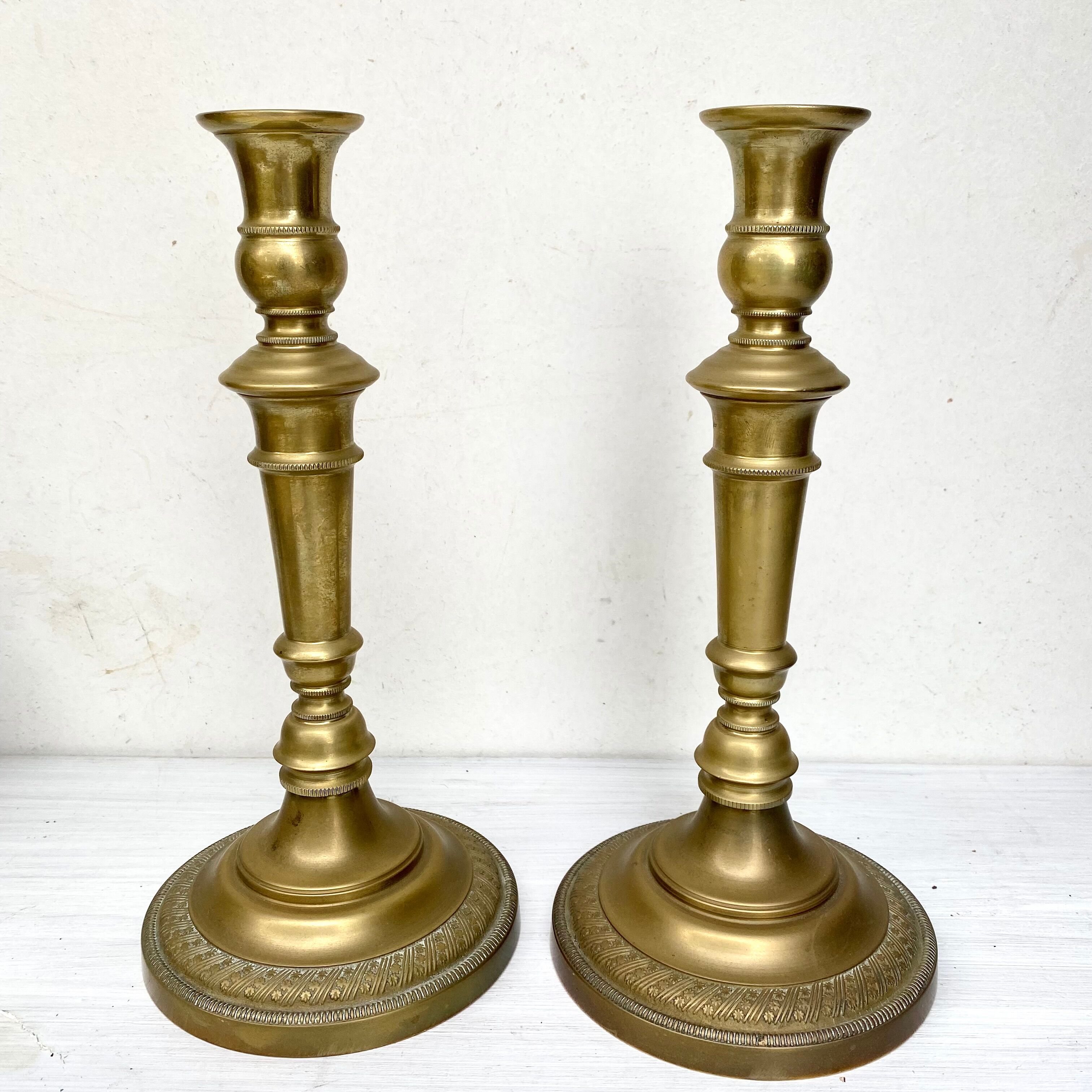 Pair of old candle holders in golden brass