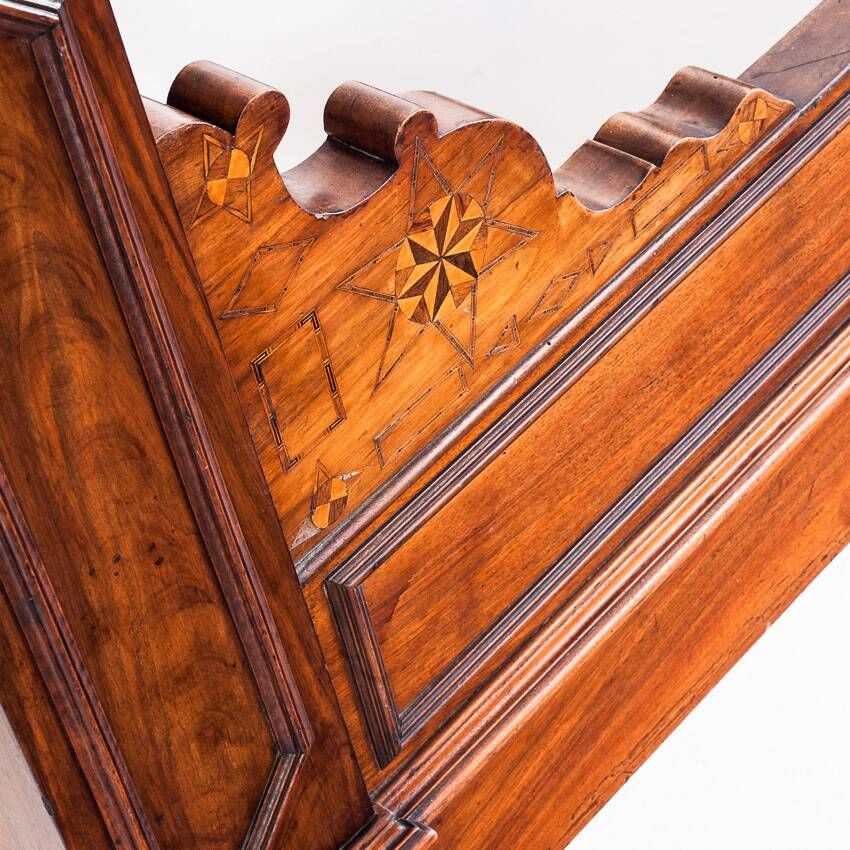 Bed made of solid walnut with marquetry details. France, 1930s.