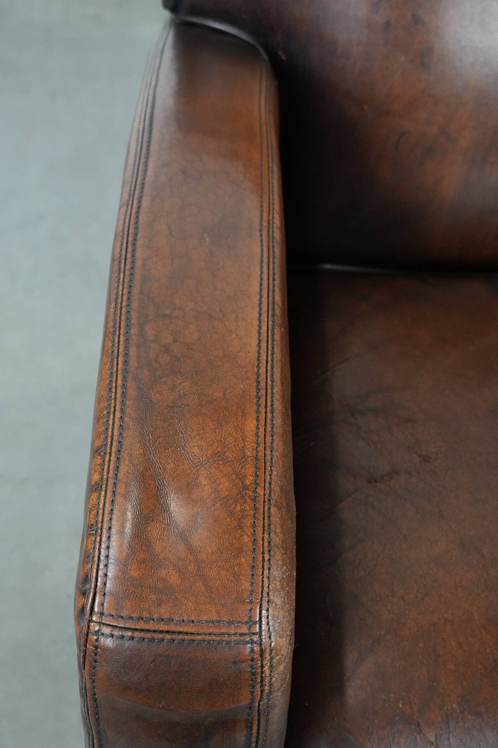 Beautifully shaped vintage sheepskin armchair with character