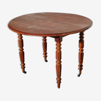 Ancienne table ronde roulante de ferme rustique en bois vintage aux côtés rabattables