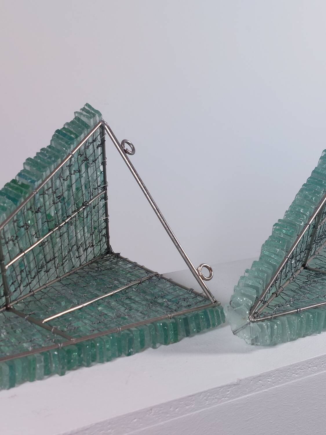 Pair of pyramid-shaped wall sconces in glass in vintage French style.