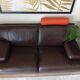 Two brown leather Crozatier two-and-a-half-seater sofas.
