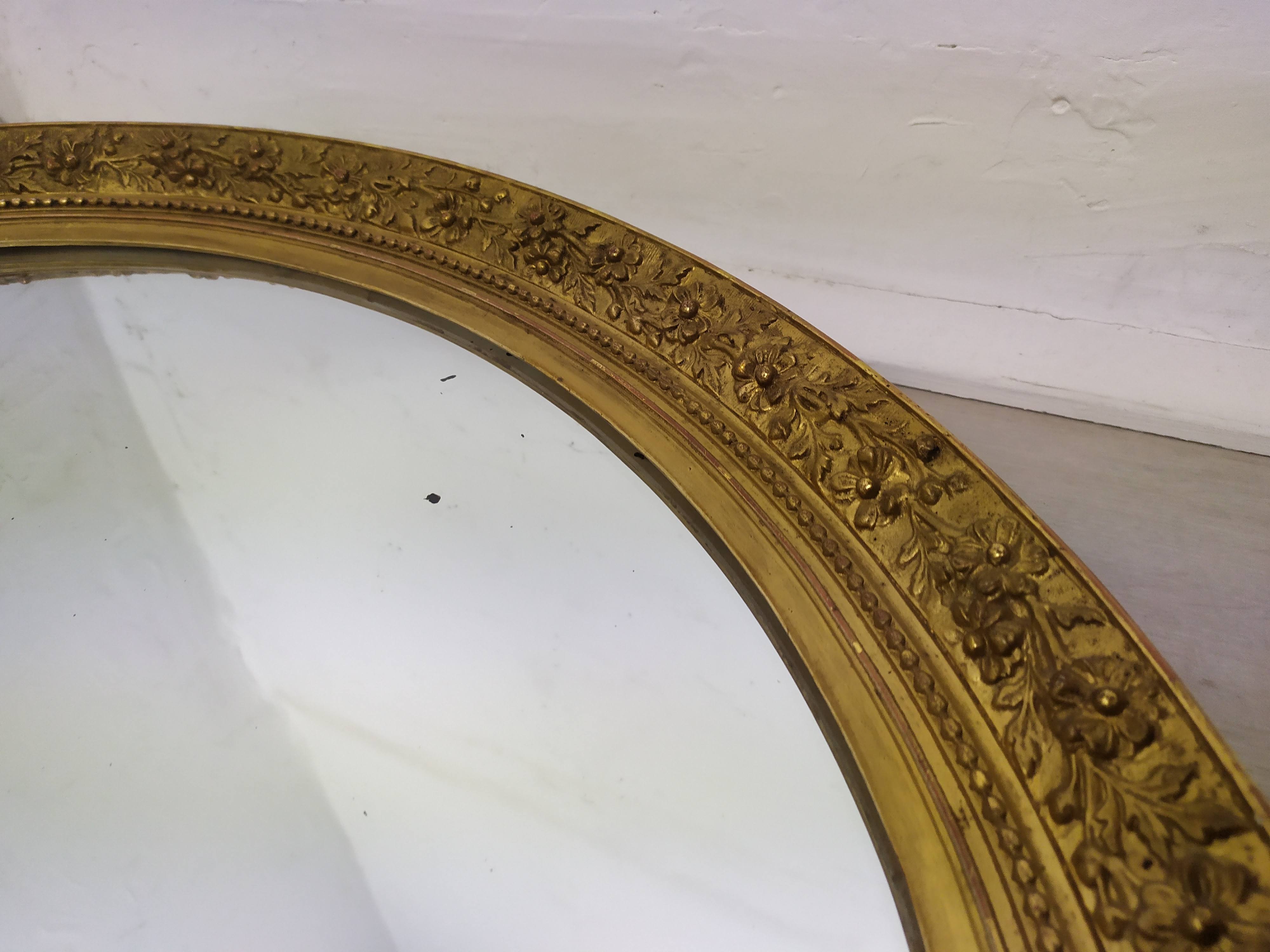 Golden oval mirror