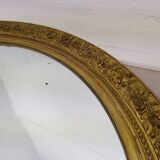 Golden oval mirror