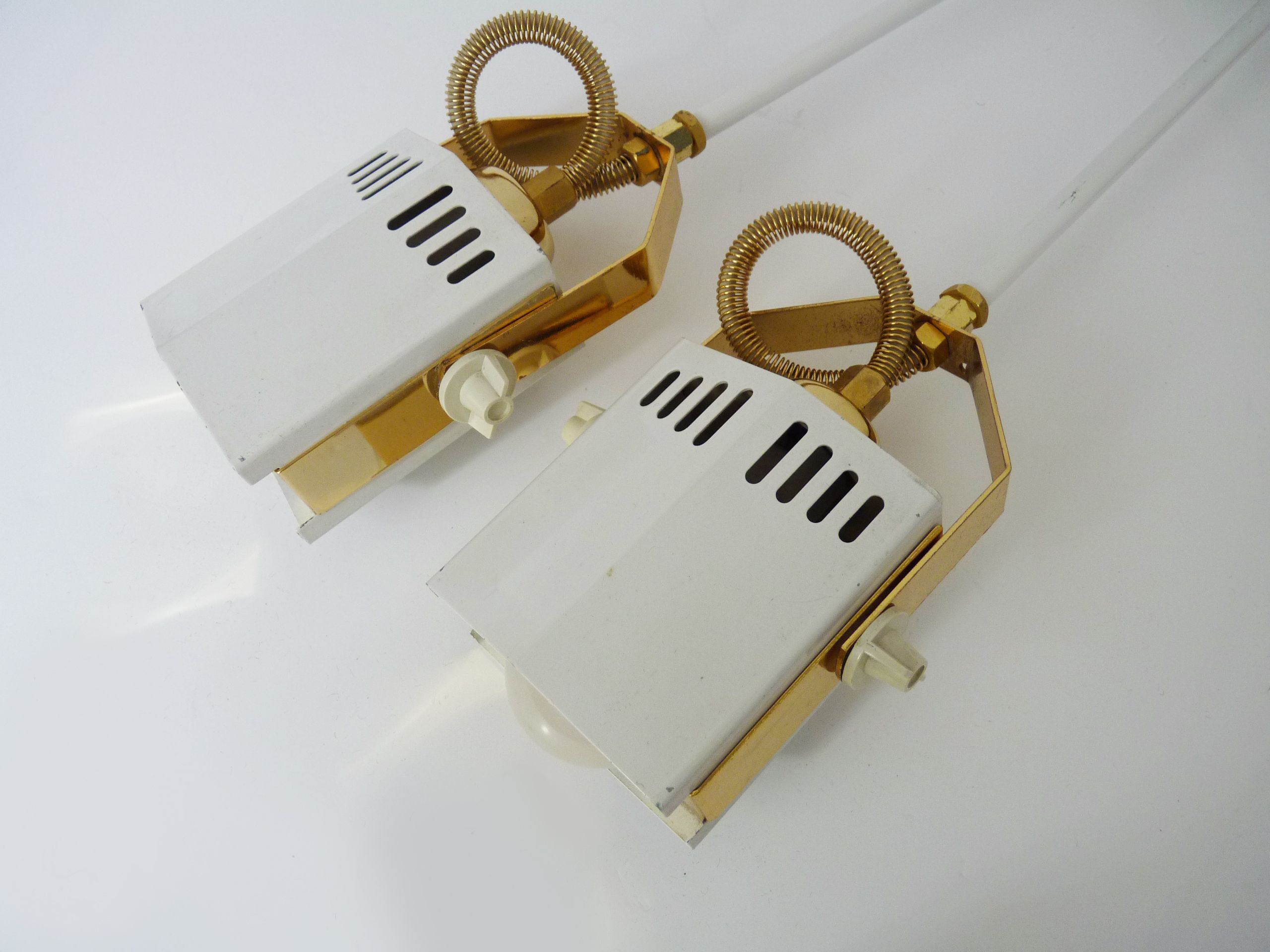 Pair of spot wall lamps adjustable design in white metal and brass. Year 80