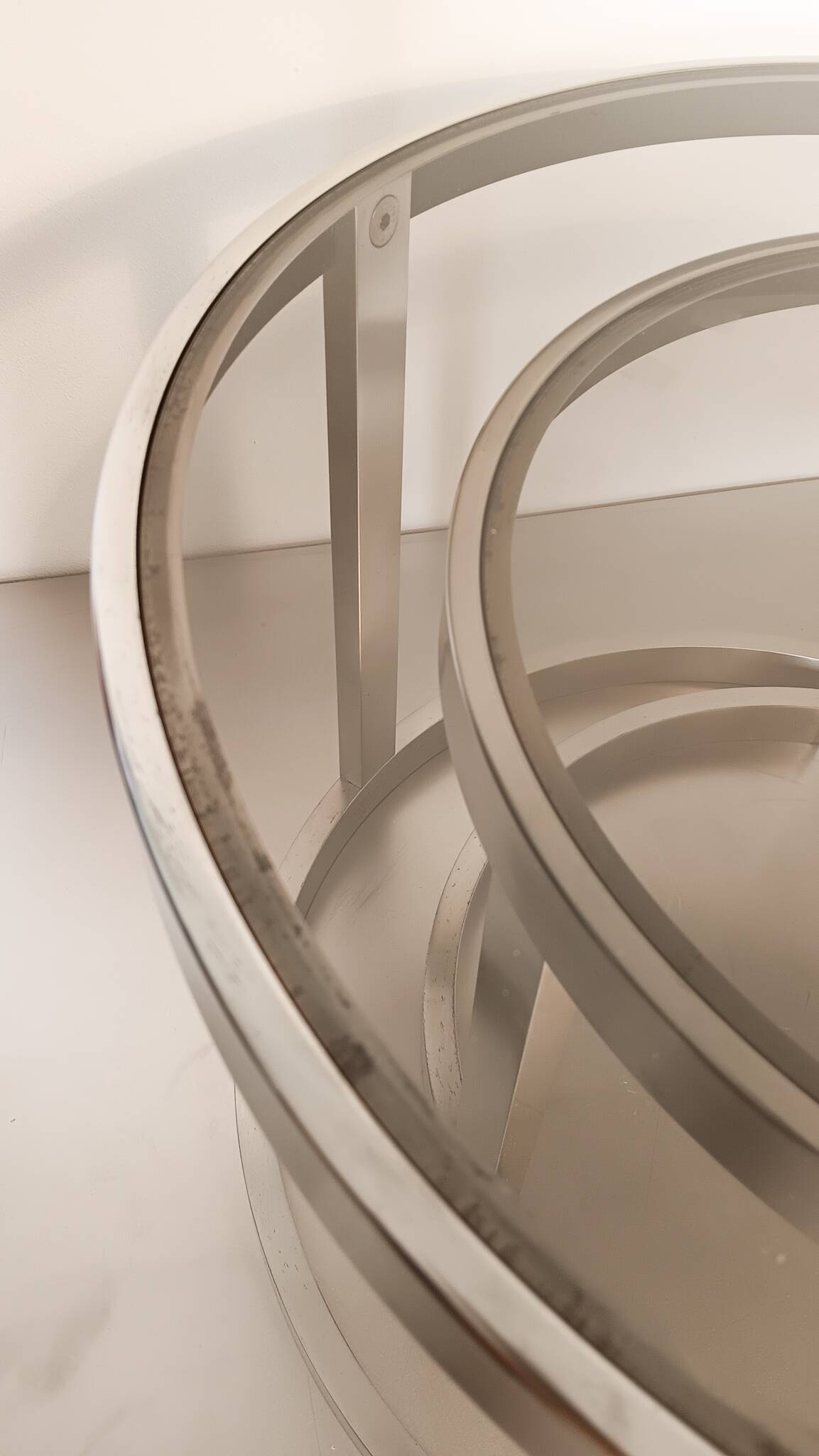 2 vintage 1970s smoked glass and brushed metal nesting coffee tables