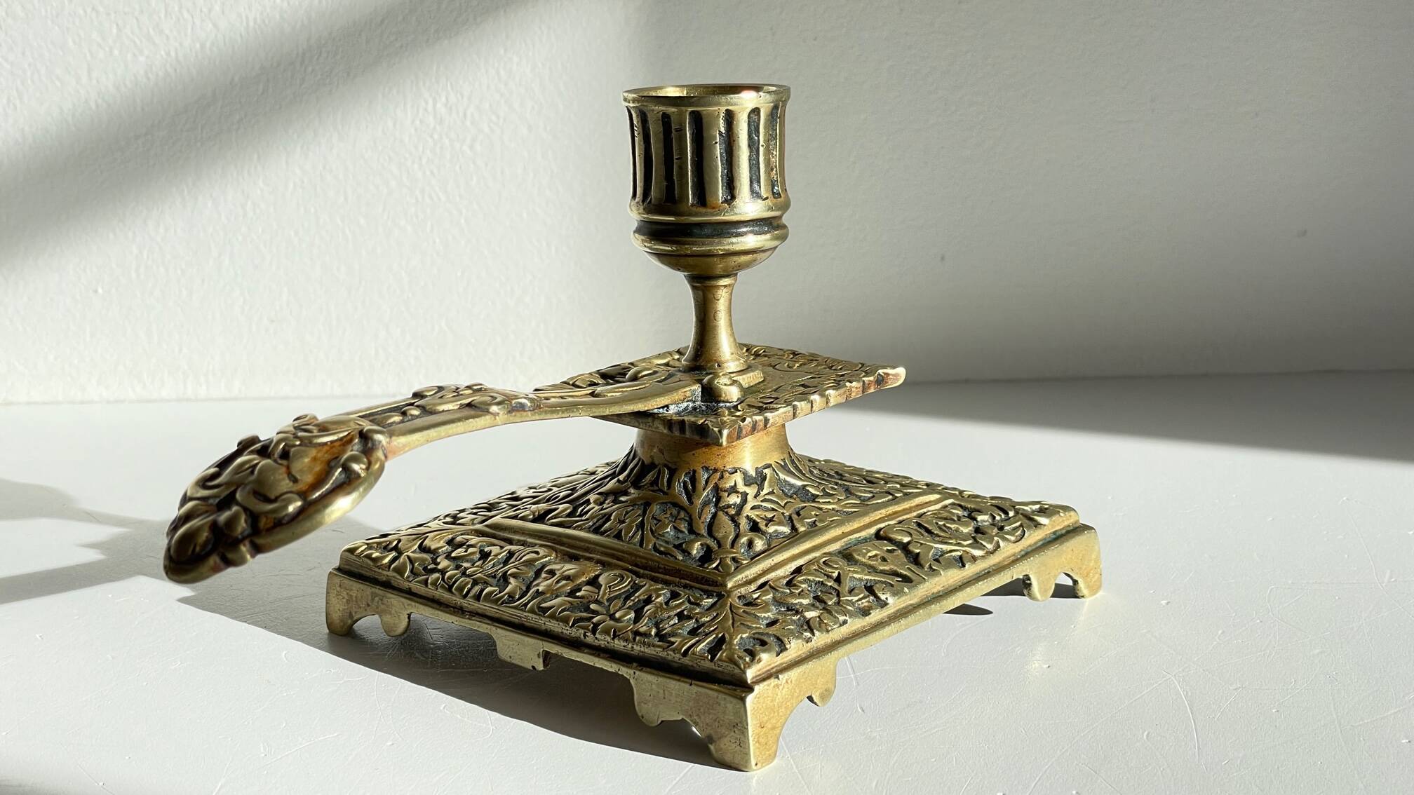 Patterned solid bronze hand candle holder