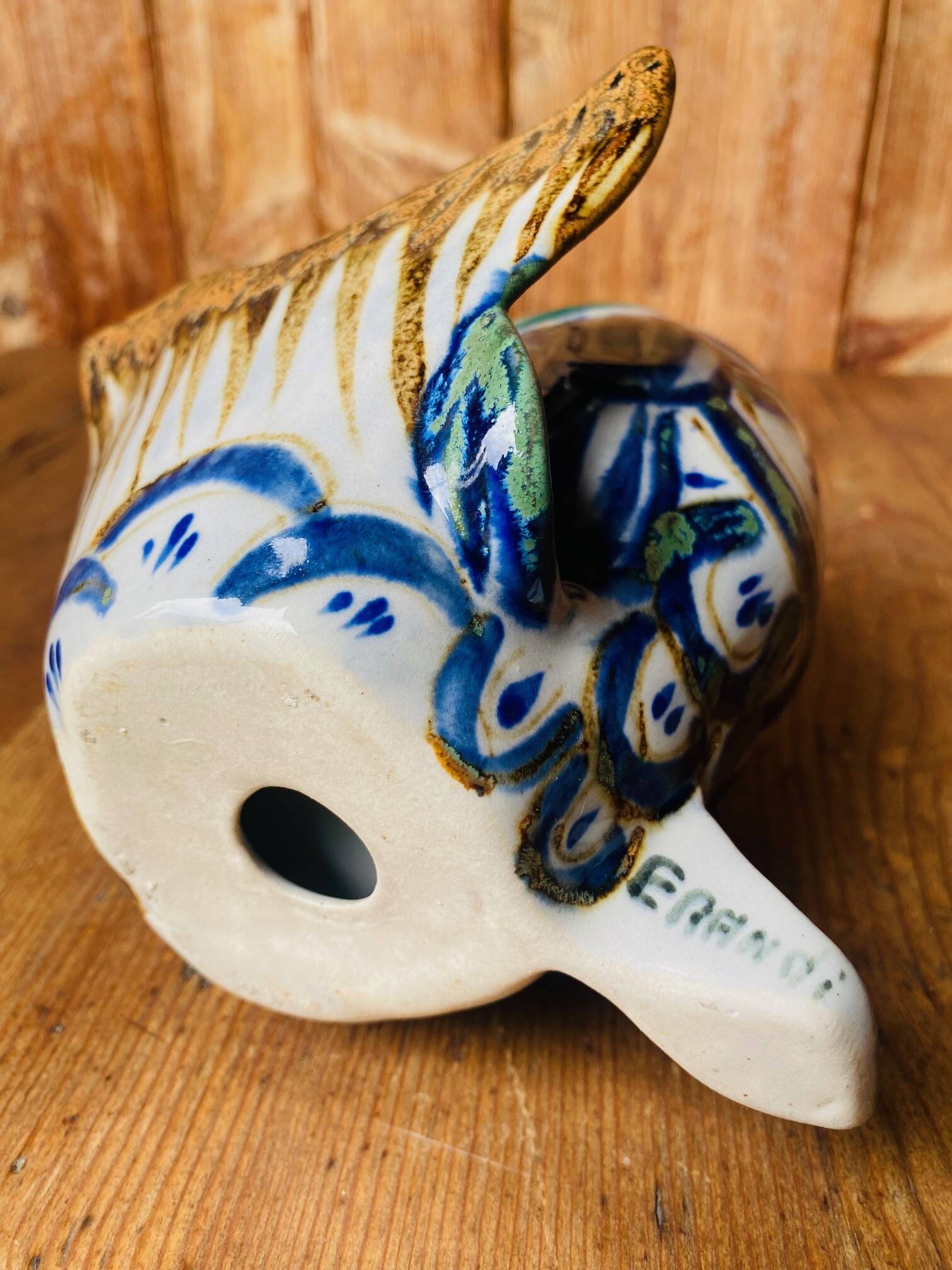 Blue ceramic zoomorphic vase in the shape of a poison.