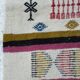 Handmade Berber kilim rug with multicoloured tribal motifs.