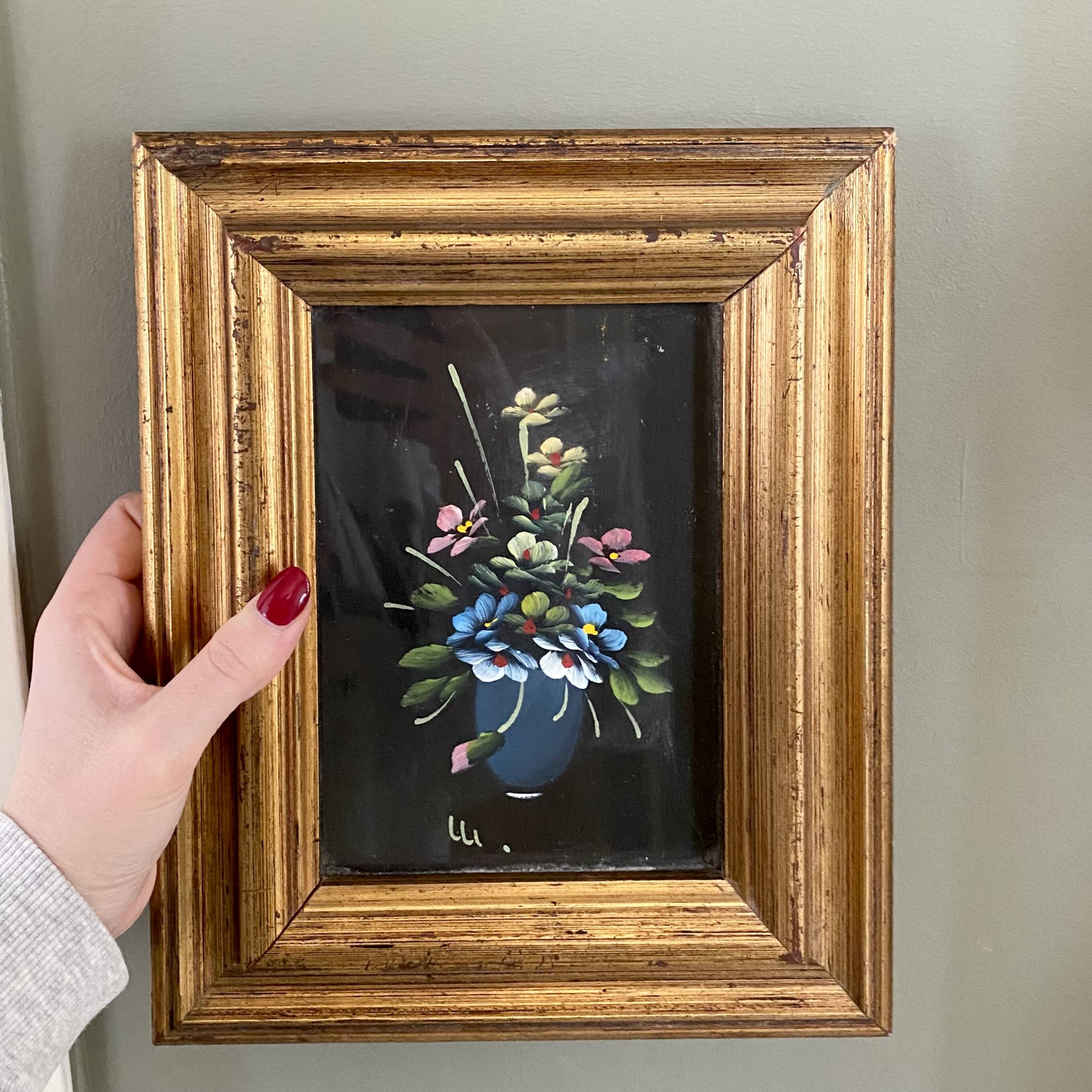Golden frame with painting bouquet of flowers