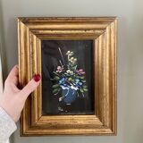 Golden frame with painting bouquet of flowers