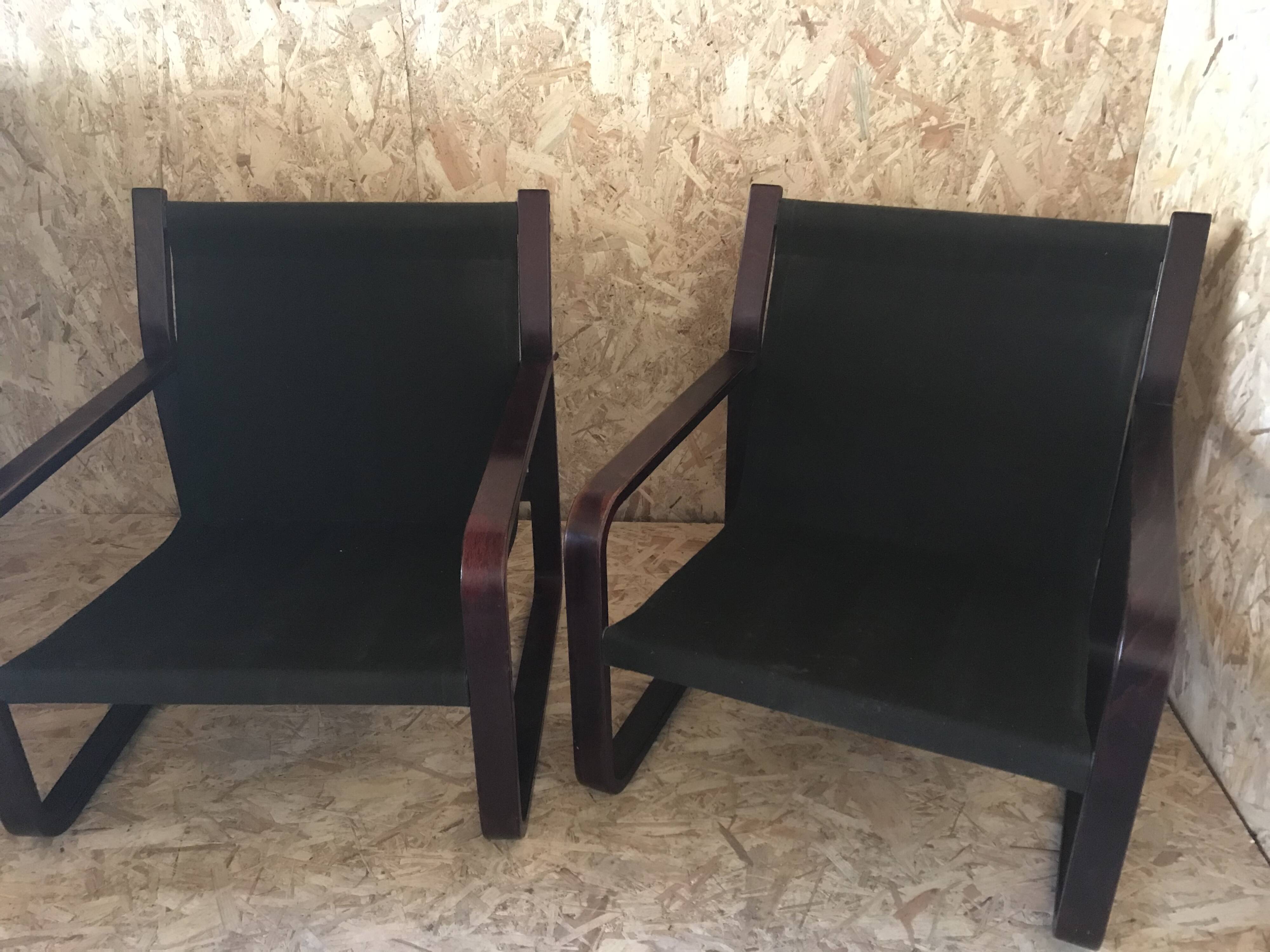 Pair of vintage armchairs in curved wood with suspended seat circa 1970-80.