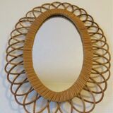 Vintage oval rattan mirror from the 60s and 70s with a rosette