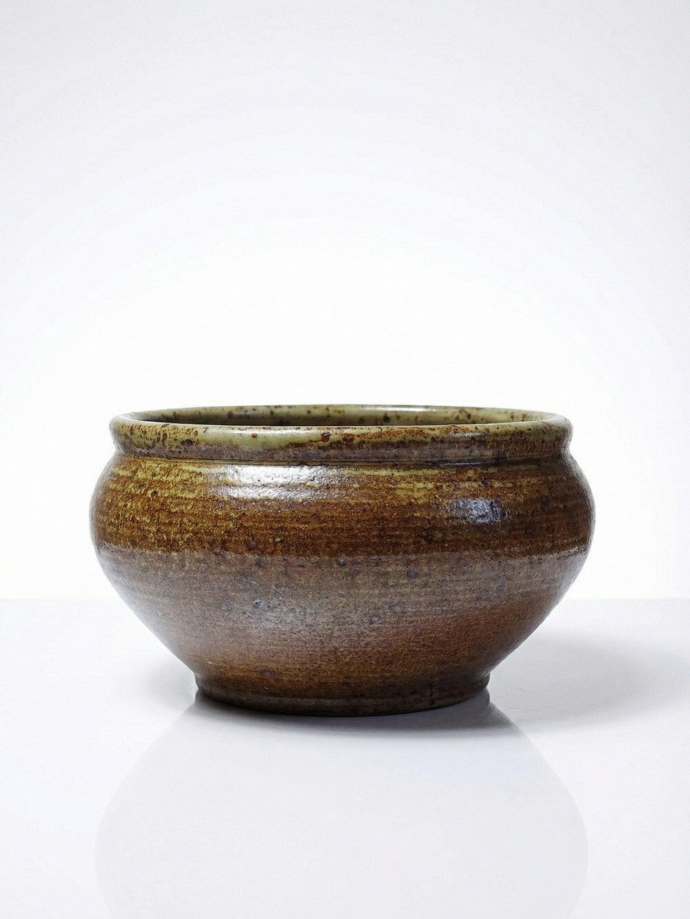 Vintage glazed stoneware bowl or planter in rustic wabi-sabi style.