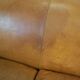 Unique old set of 2 club armchairs and a couch in cognac-colored leather with wheels
