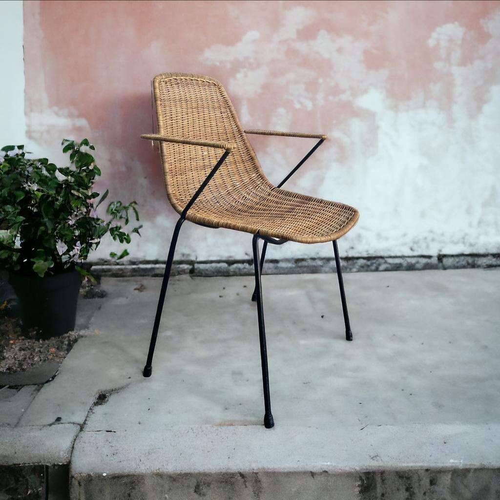 Vintage wicker chair with black steel frame and armrests