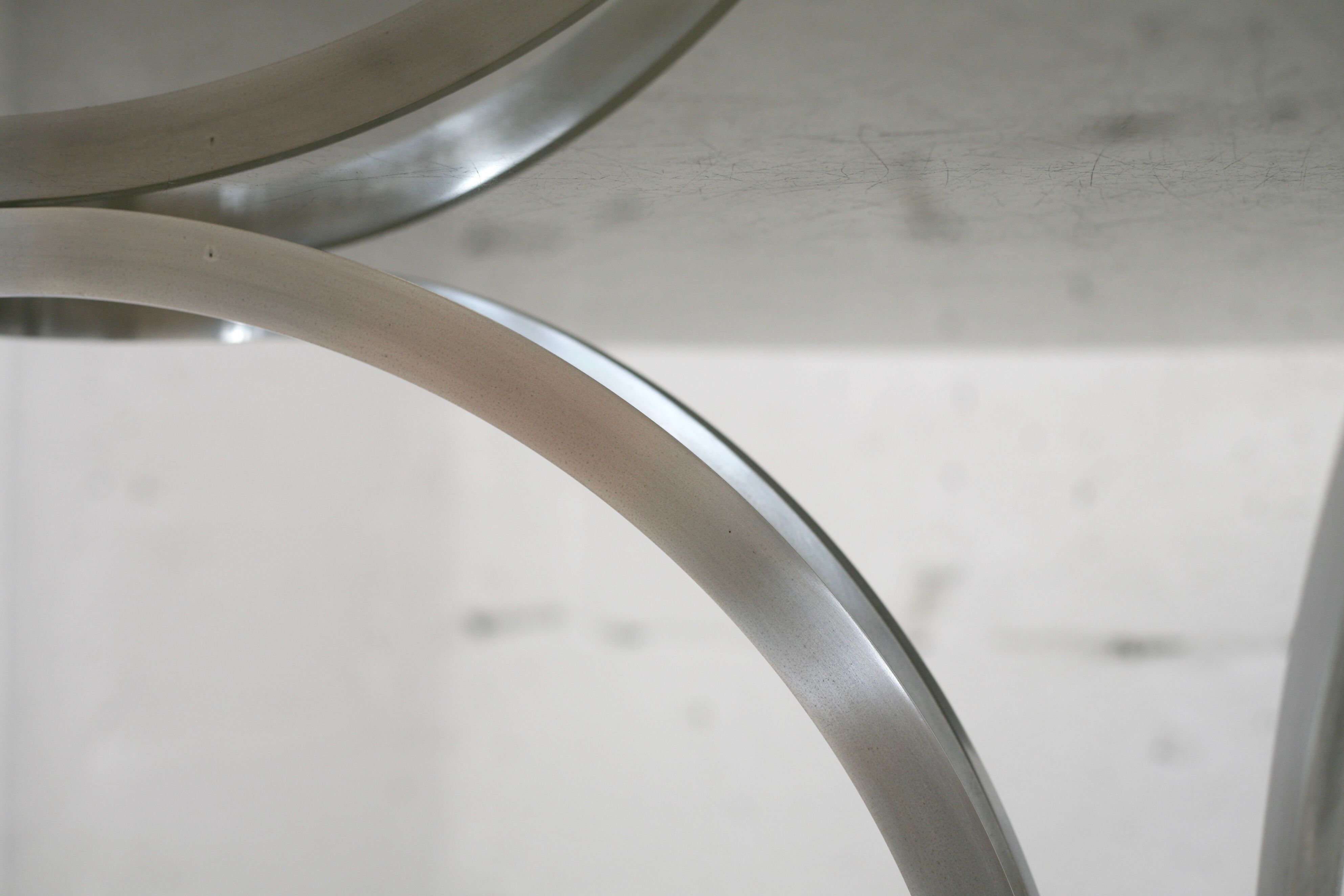 Living room table "Space Age" polished steel, circular slab smoked glass. France, circa 1970.