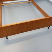 Double bed vintage modernist in teak and black metal from the 1960s with bedside tables.