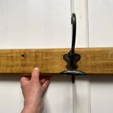 Antique wooden coat rack with metal hooks