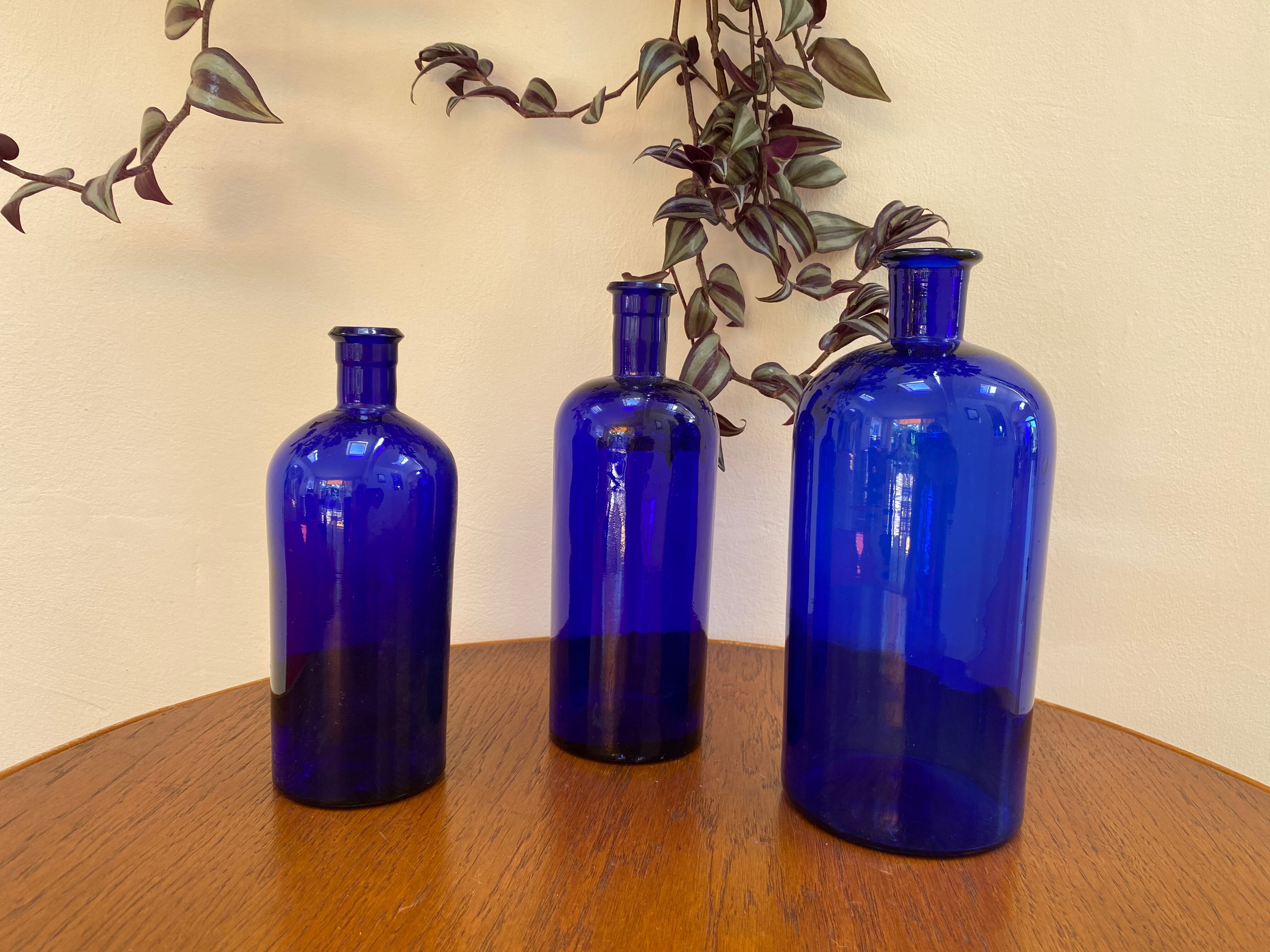 Trio of apothecary bottles in cobalt blue glass