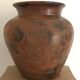 Vase or pot in brown terracotta with artistic decoration of fish.