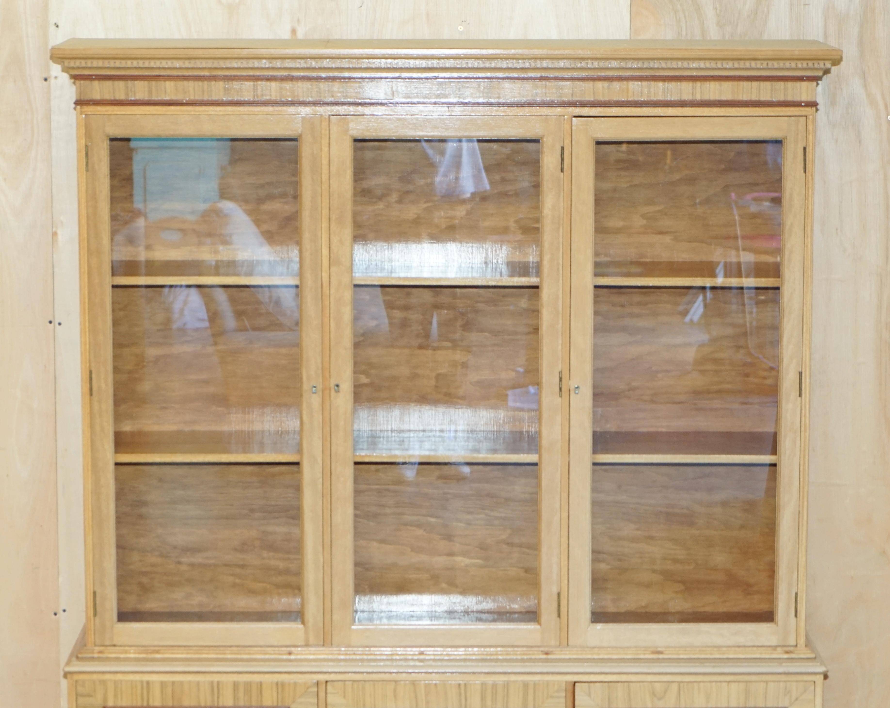 Library in the style of David Linley in satinwood, walnut, and rosewood.
