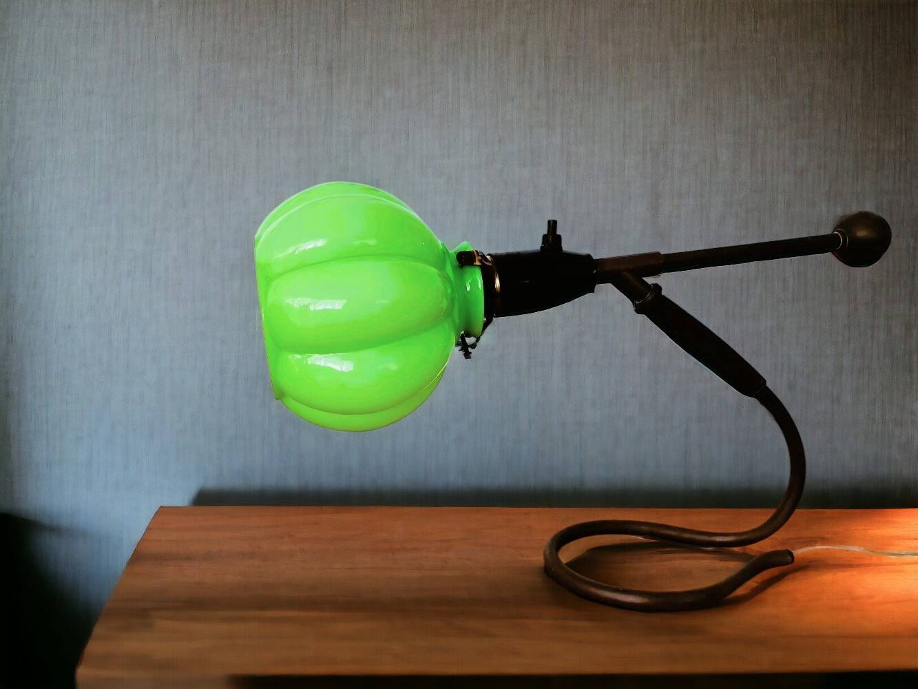 Modernist green cased glass and brass articulated table lamp