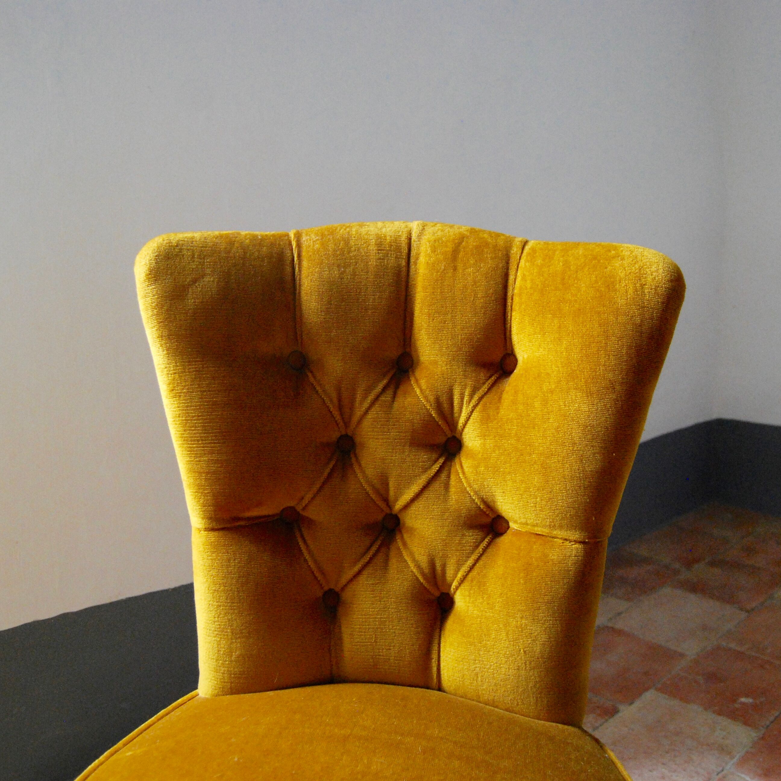 Toad in yellow velvet armchair