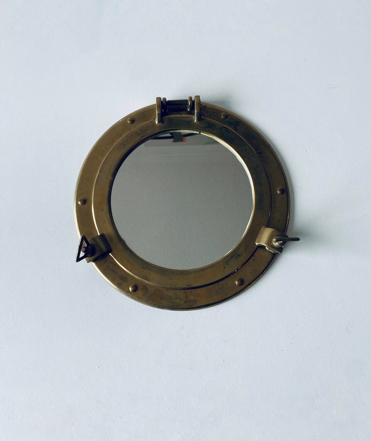 Porthole mirror in gilded brass