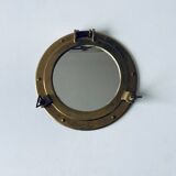 Porthole mirror in gilded brass