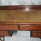 Old desk in cherry and green leather