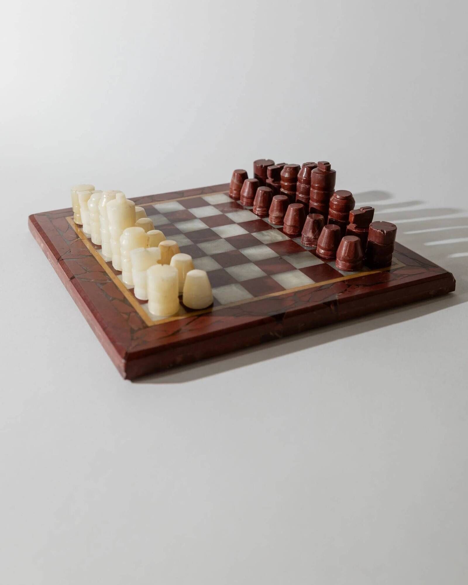 Vintage marble chess set from the 1960s, cream, burgundy and gold board with metal inlay, stone pieces.