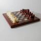 Vintage marble chess set from the 1960s, cream, burgundy and gold board with metal inlay, stone pieces.