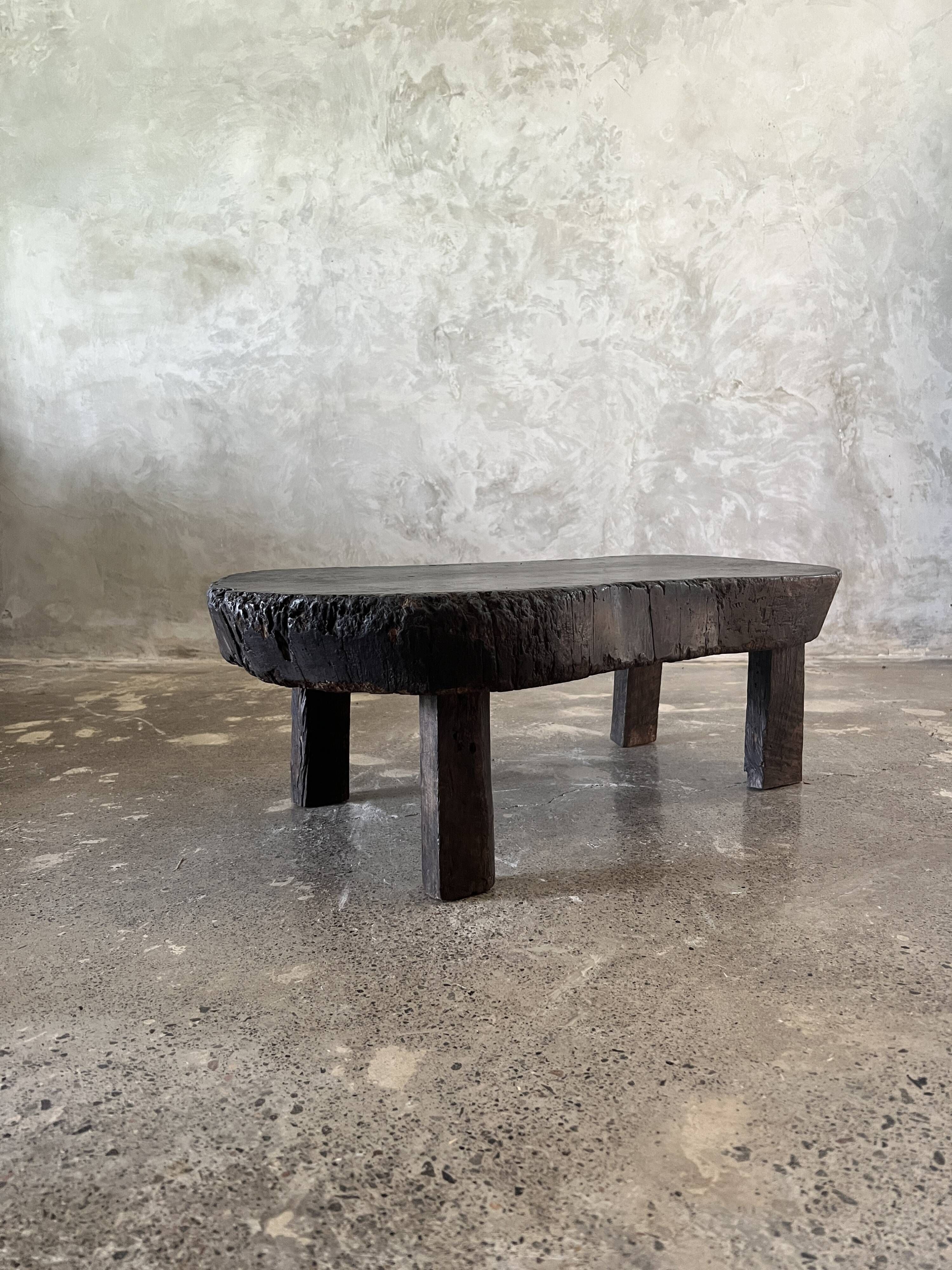 Small old Asian wooden coffee table in Japanese style, kidney-shaped top