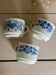 Set of 3 antique ceramic cups with blue floral pattern.