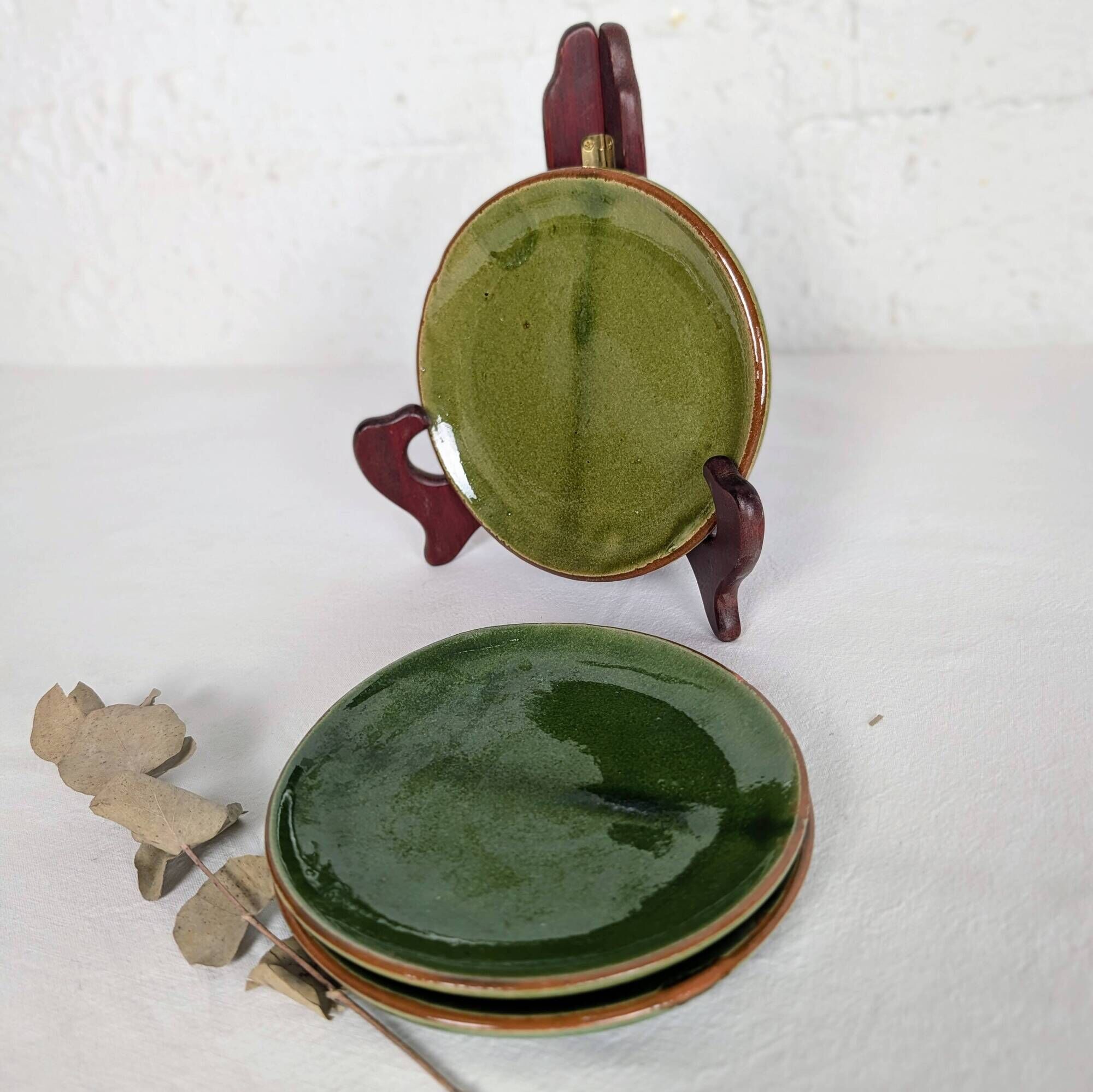 Small plate in glazed green earthenware