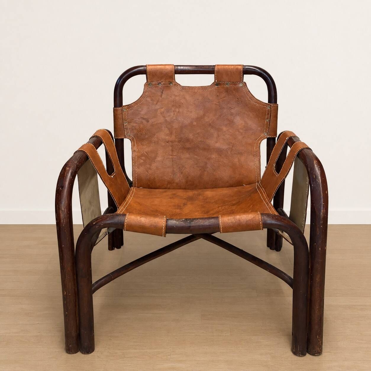 Pair of Tito Agnoli armchairs in leather and bamboo, 1970s.