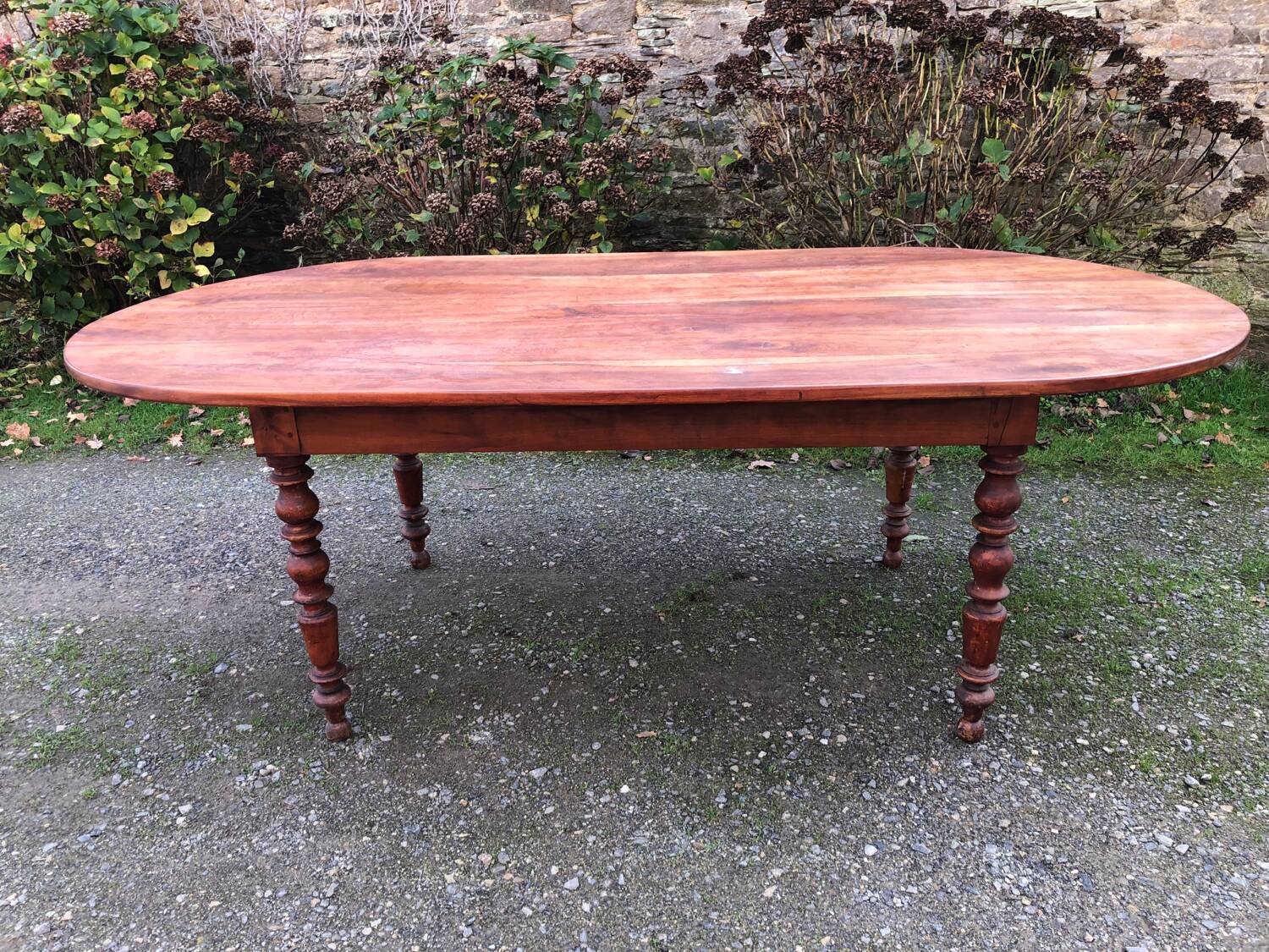 Antique cherry wood farmhouse table with rounded ends