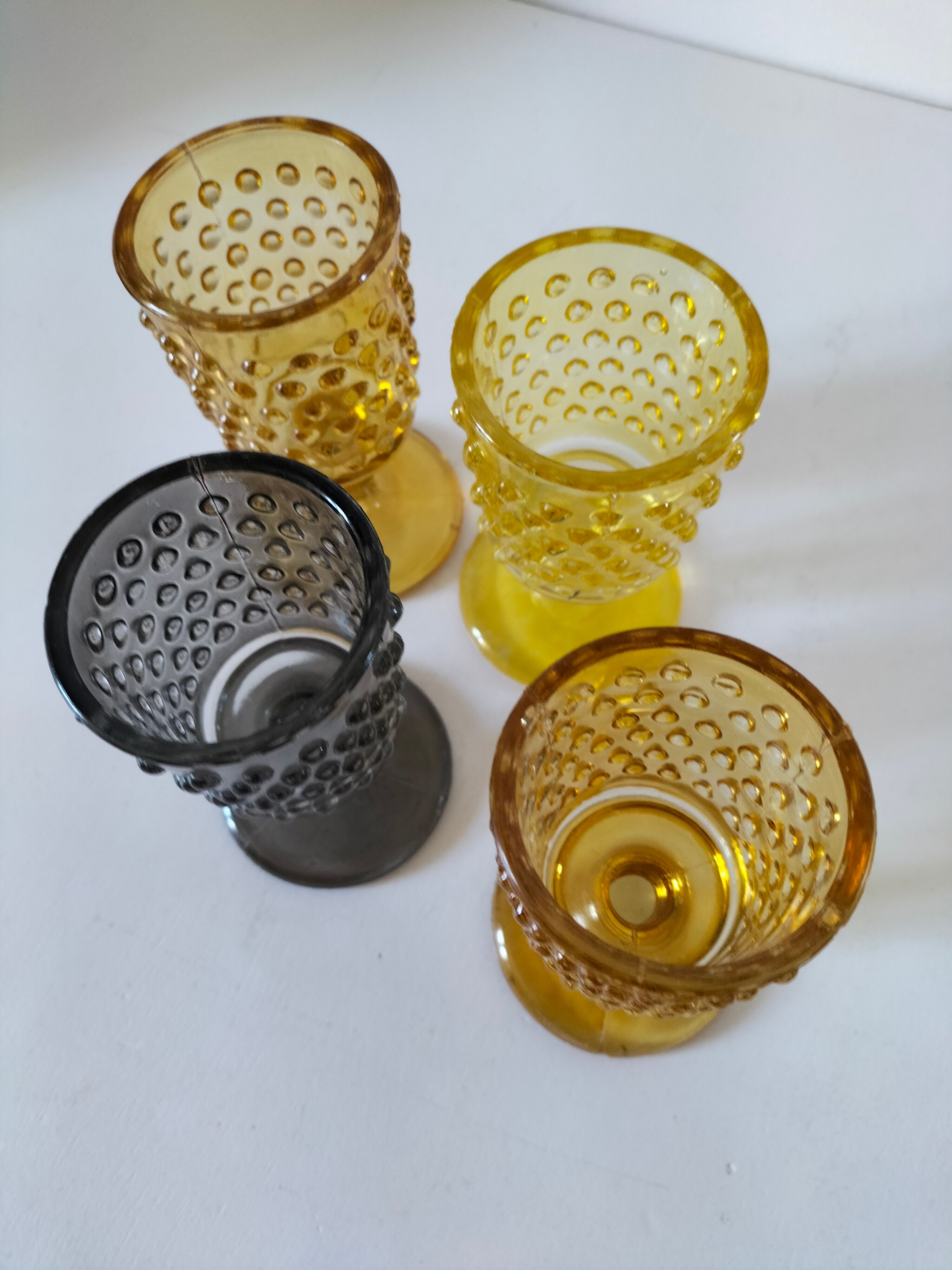 4 vintage stemmed glasses in hobnail glass and smoke colour.