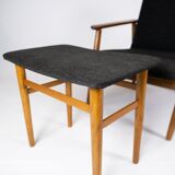 Easy chair with stool in teak and dark wool fabric of danish design from the 1960s.