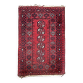 Tapis d'Orient Boukhara en laine à décors géométriques sur fond rouge,