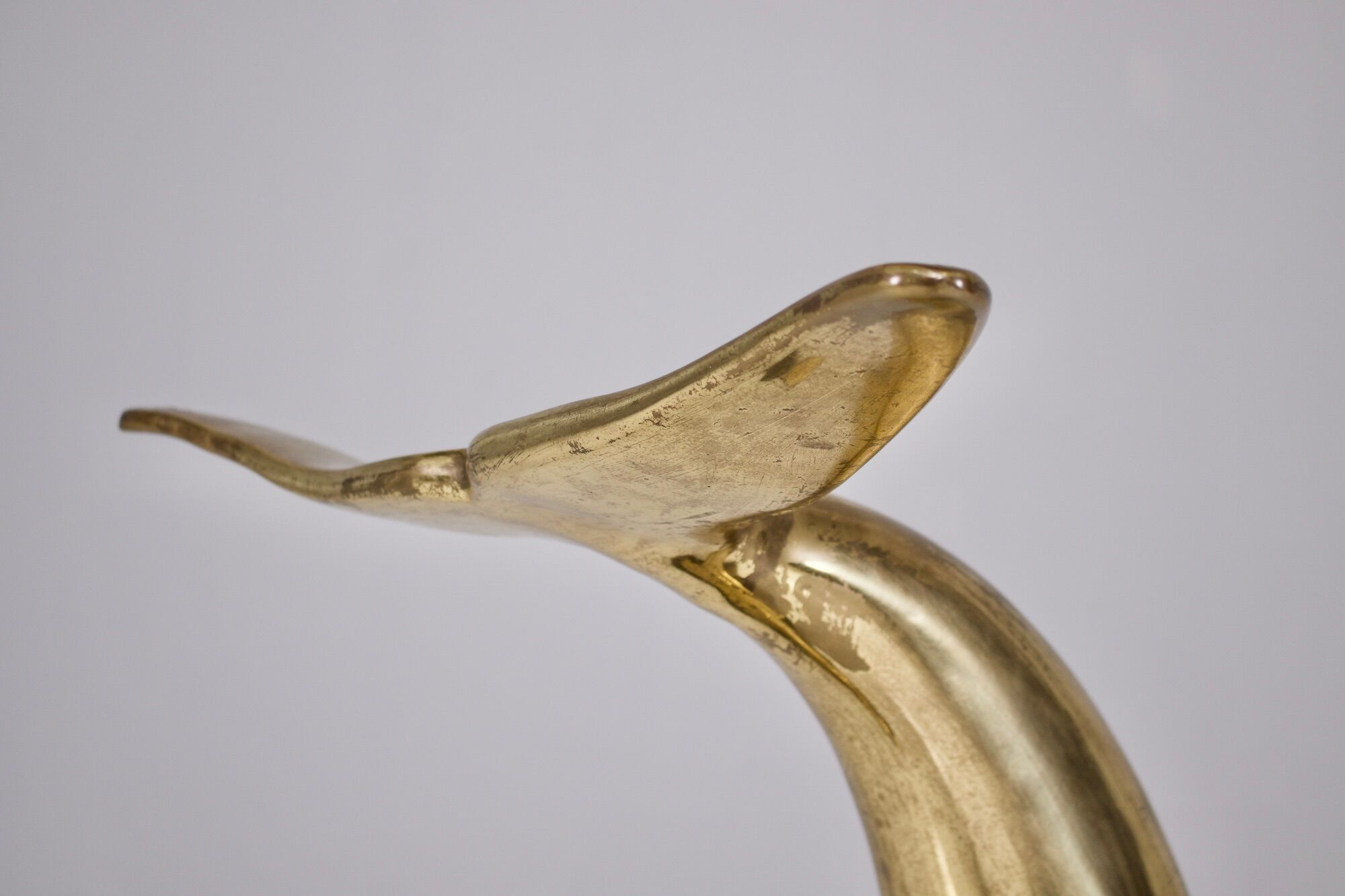 Solid brass dolphin console feet.